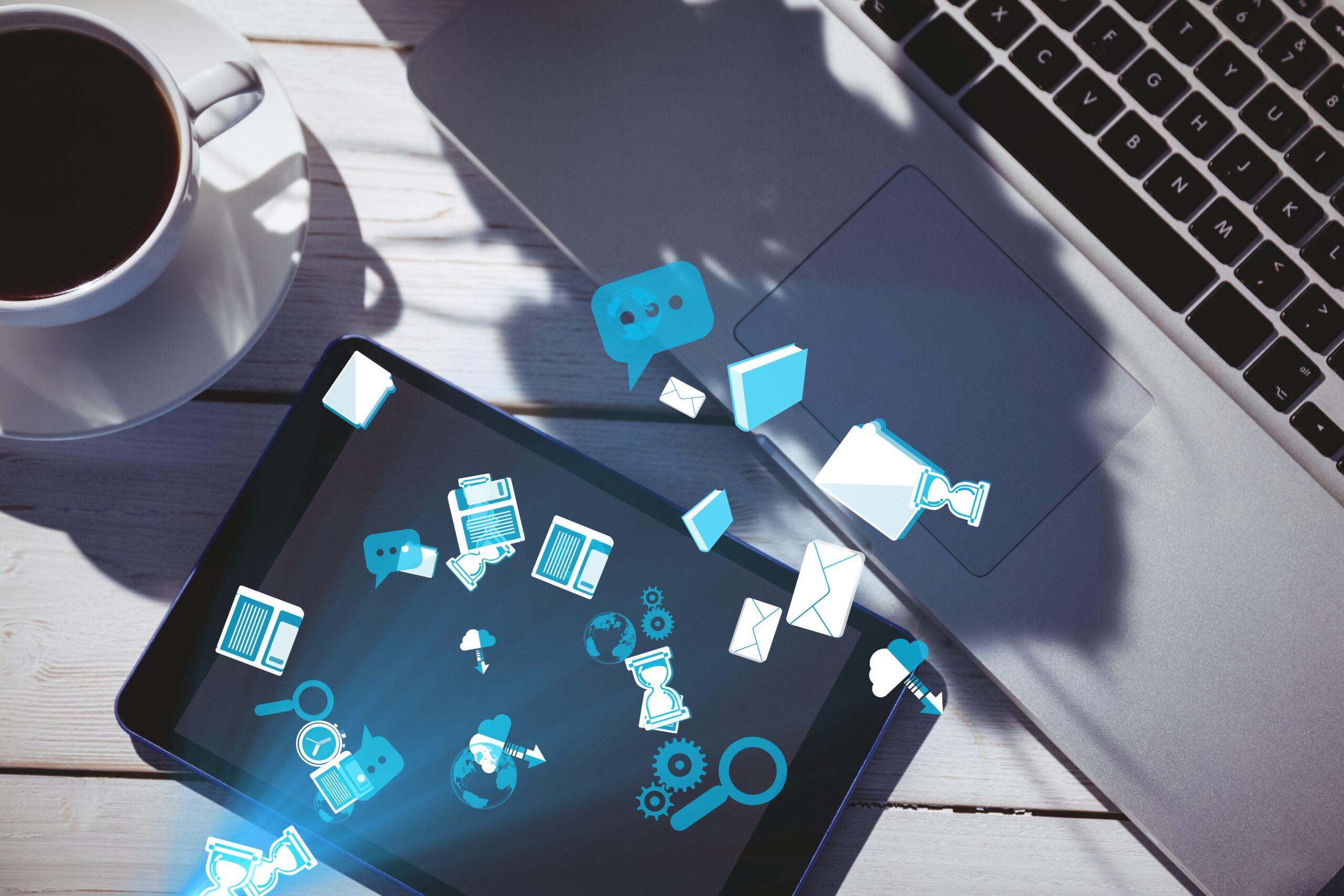 digital composite of smart devices with coffee on table with graphics